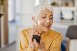 Senior woman applying makeup